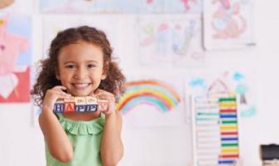 preschool girl holding blocks