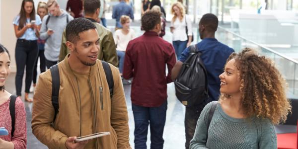 NAEYC Accredited Higher Education Programs Adult students walking down a hallway