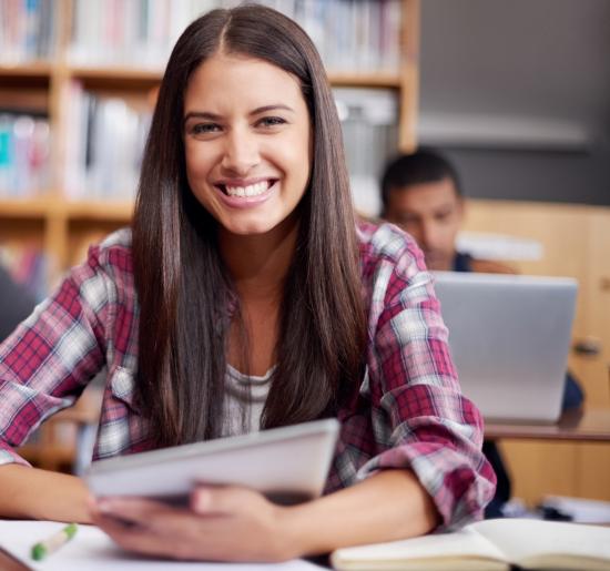 Become a Peer Reviewer woman holding a notebook and smiling
