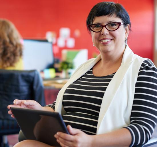 Accreditation Research Databases Woman holding electronic tablet
