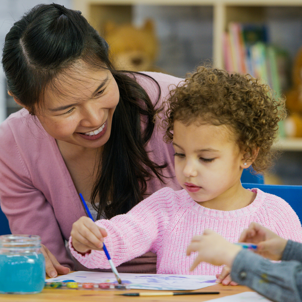 Overview of the NAEYC Higher Education Accreditation Process Teacher watching young child paint