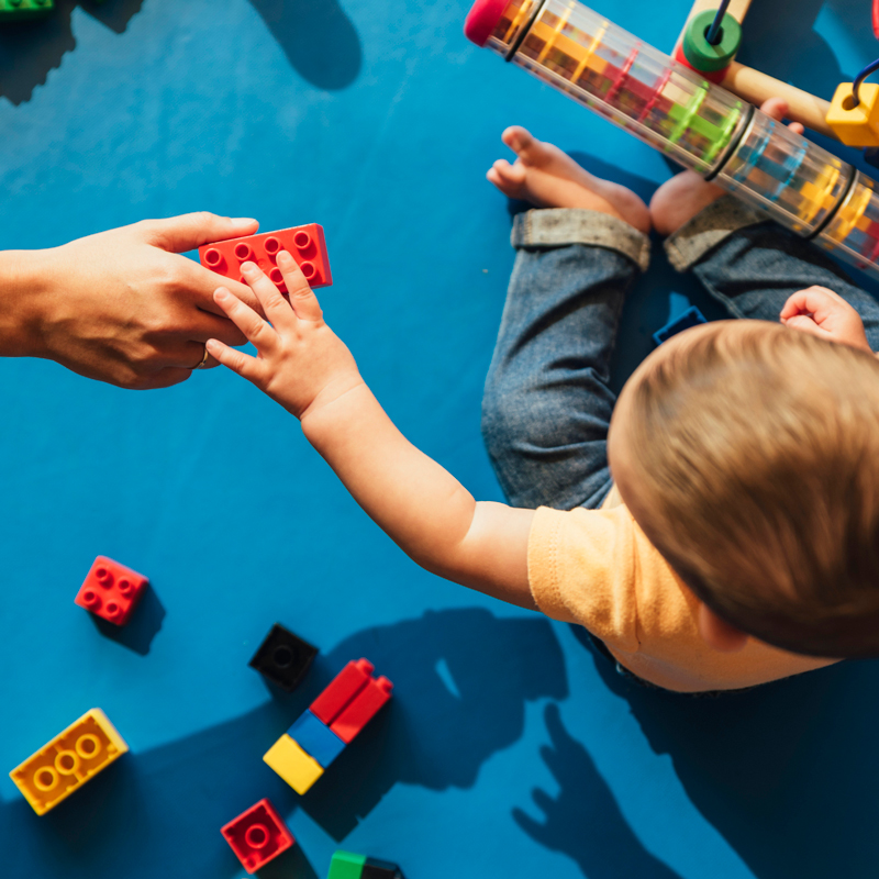 Early childhood is a crucial time for development and the momentum to invest is growing in countries around the world. A toddler reaches for a building block from an adult